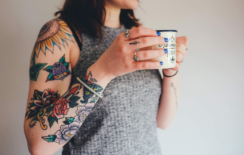 Image of woman with numerous tattoos on her arms