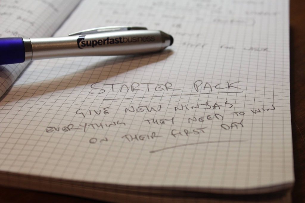 Image of notebook with pen, and text "Starter Pack - Give new ninjas everything they need to win on their first day"